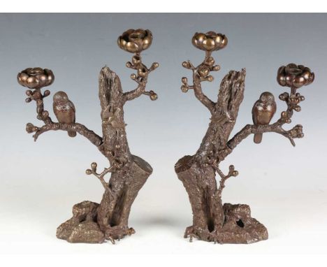 A pair of 20th century brown patinated cast bronze twin-light candelabra, probably Japanese, the naturalistic tree stump stem