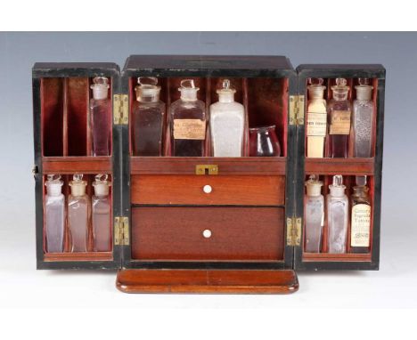 A late George III mahogany apothecary's travelling case, the top with recessed brass handle above two doors opening to reveal