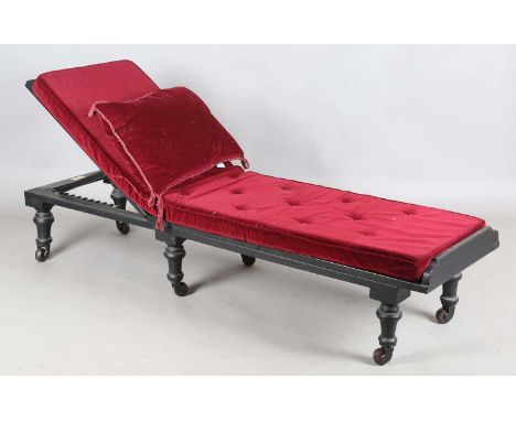 A late Victorian black painted adjustable daybed by 'John Carter, Literary Machine, London', the adjustable caned panels on t