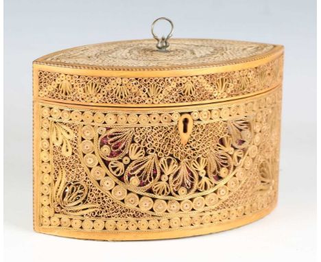 A George III paper scrollwork tea caddy of elliptical form, the hinged lid and sides finely worked with overall scrolling gil