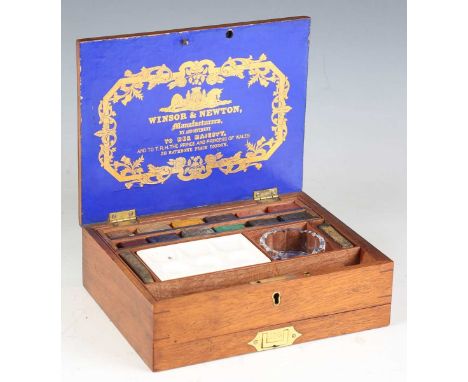 A late Victorian mahogany cased artist's box by Winsor &amp; Newton, 'By Appointment to Her Majesty', the lid with gilt blue 