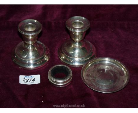 A small quantity of Silver including a pair of weighted candlesticks (1956), napkin ring (1996) and small dish (1982) 37 gms.