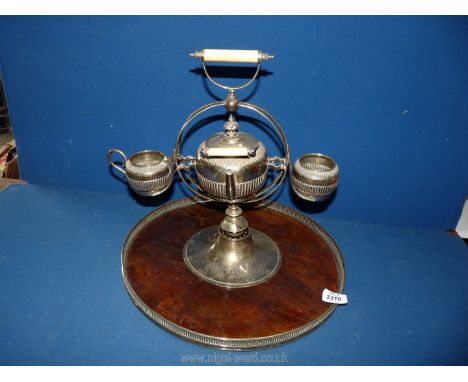 A plated teapot and milk jug on revolving Tray. 