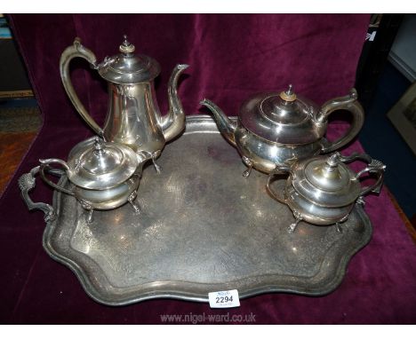 An Epns hot water jug, teapot, tea for one pot and sucrier on paw feet, standing on two handled engraved tray.