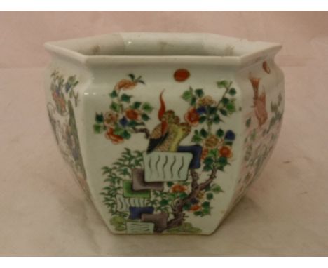 A 19th Century Chinese Kangxi palette polychrome decorated jardiniere of hexagonal form each panel decorated with bird amongs