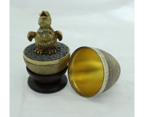 A Stuart Devlin silver gilt egg opening to reveal a chick (London 1971) over all weight 4.98 oz together with stand in Boodle