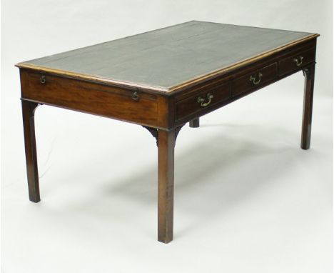 A George III mahogany library table in the Chippendale manner, the tooled leather insert top over three frieze drawers with b