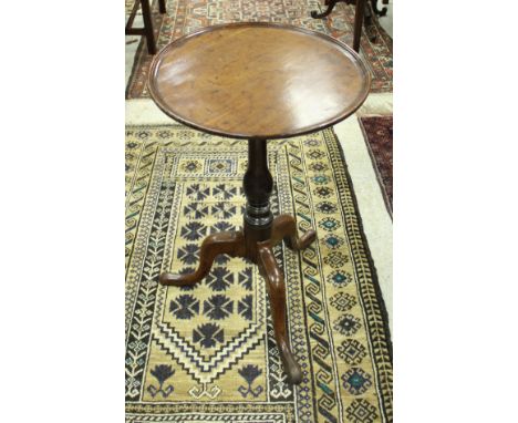 An 18th Century walnut and oak occasional table, the circular dished top on a baluster turned pedestal to cabriole tripod bas