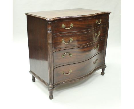 A late George III mahogany serpentine fronted chest in the manner of Chippendale and Haig, the top cross-banded and with moul