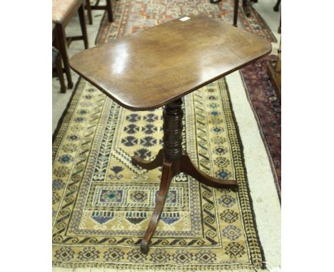 An early 19th Century mahogany occasional table, the rounded rectangular snap top on a turned and ringed pedestal to splayed 