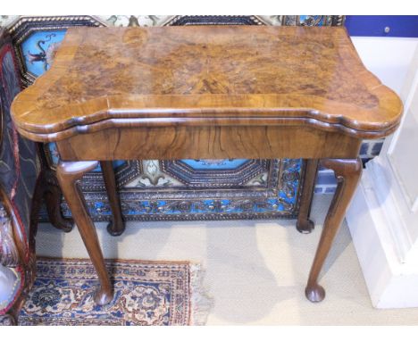 A walnut and feather-banded fold-over card table in the early 18th Century manner, the top opening to reveal counter and card