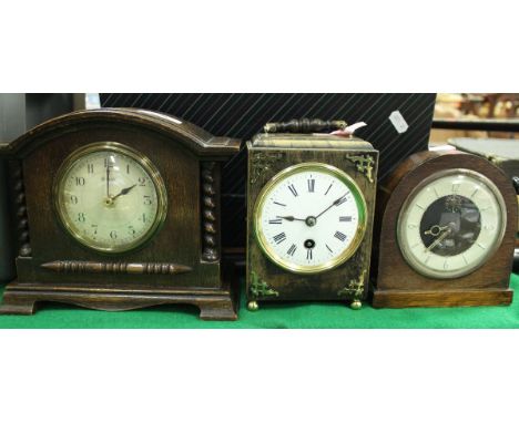 A 19th Century French ebonised cased mantel clock with circular enamelled dial and Roman numerals, together with a French oak