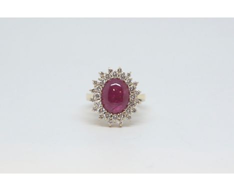 Cabochon ruby and diamond cluster ring, central 13x9mm cabochon cut ruby, within a double row border of brilliant cut diamond
