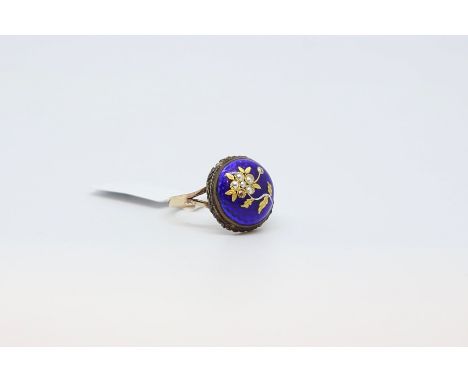 Enamel flower ring, circular blue enamel with a gold coloured flower to the centre, with a rope detailed border, mounted in y