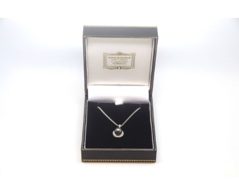 Black pearl and diamond pendant, 7mm black pearl with a diamond set border, 43cm chain, in white metal stamped and tested as 