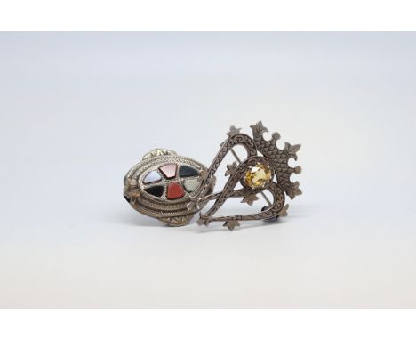 Two silver brooches, one in the form of two intersecting hearts under a crown, and set with a central oval citrine, together 