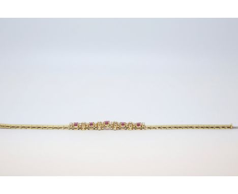 Ruby and diamond line bracelet, centrally set with five oval cut rubies, each separated by a diamond set daisy cluster, with 