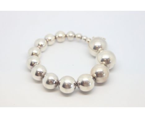 Georg Jenson silver bracelet, sixteen graduating silver beads, on a silver wire style bracelet, length approximately 21.5cm, 