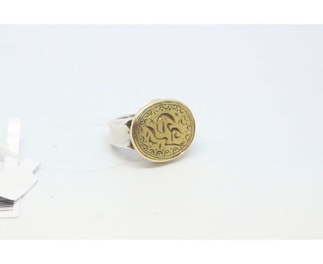 Silver emblem ring, with a yellow metal carved top, ring size P