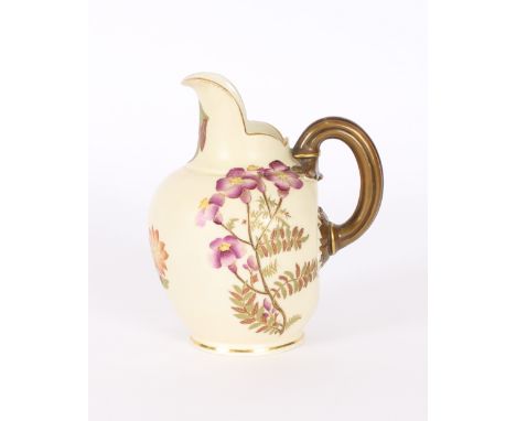 A Royal Worcester cream jug, having painted floral decoration on a cream ground, heightened in gilt, 15cm high