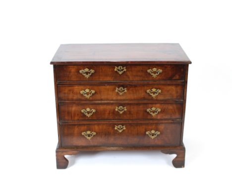 An 18th Century mahogany and walnut dressing chest, the top drawer with fitted interior, three long drawers below, raised on 