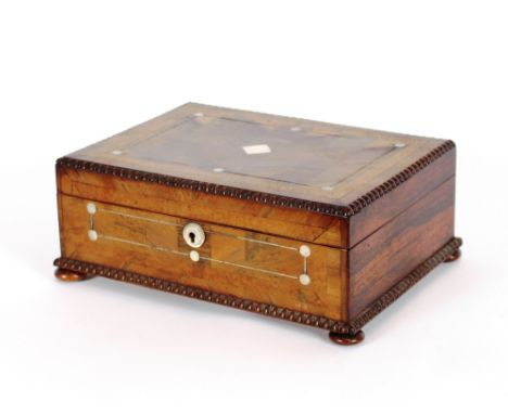 A 19th Century rosewood sewing box, having mother of pearl inlay, complete with contents to include: a rosewood sewing clamp,