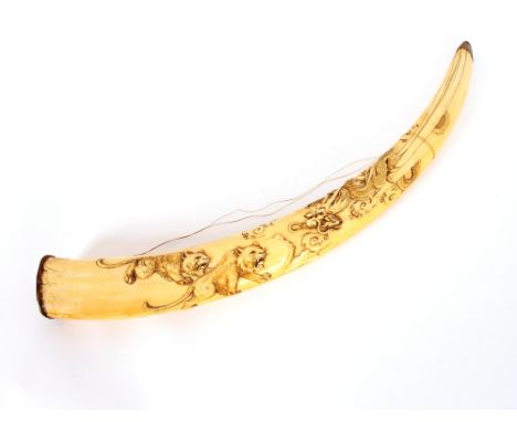 A Japanese carved ivory tusk, with dragon decoration, 61cm long