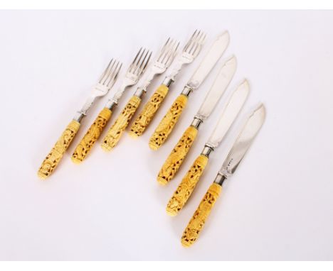 Four silver bladed fish knives, and four matching forks, hallmarked for London 1875 and 1888, with finely carved ivory handle