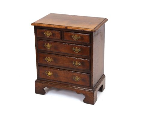A good quality reproduction oak chest, in the 18th Century style, of small proportions, fitted two short and three long drawe