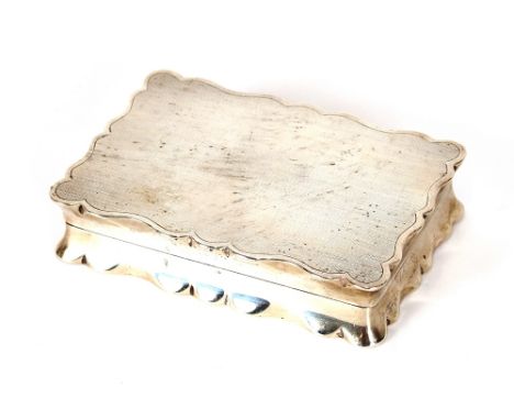 A silver hinged box, of cartouche shape with gilded interior and presentation inscription, engine turned decoration to the ou