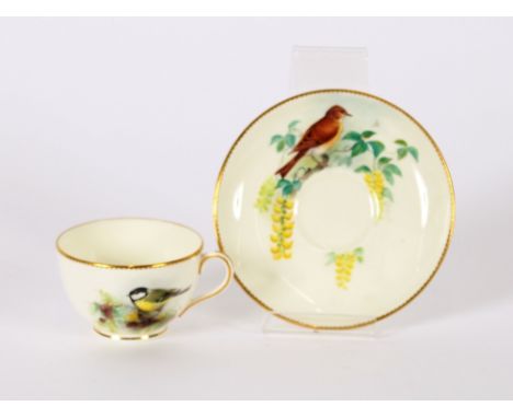 A Royal Worcester cup and saucer, decorated with birds amongst foliage, by Powell