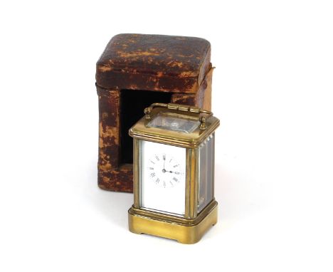 A miniature brass cased carriage timepiece, contained in a fitted leather carrying case, white enamel Roman numeral dial, 10c