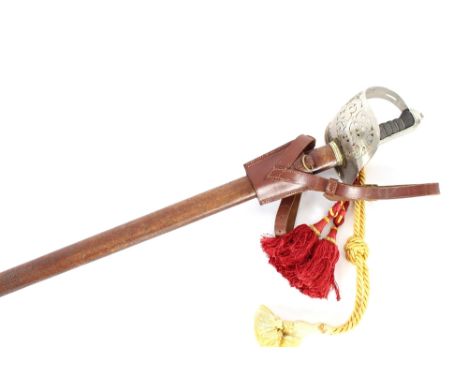 An Army dress sword, with pierced basket hilt and shagreen grip handle, complete with leather scabbard, foliate engraved blad