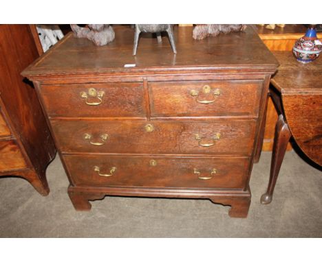 A Georgian oak and mahogany banded chest, of two short and two long drawers, raised on bracket feet, 94cm
