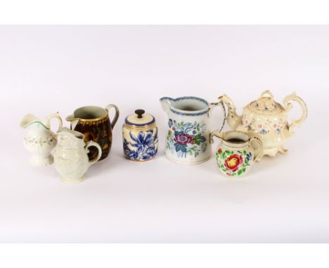 A pottery tobacco jar; a large Victorian pottery jug with floral decoration; 4 smaller similar jugs; and a floral decorated R