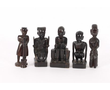 A carved ebony figure of a crouching man; another of a figure playing drums; a seated naked female figure and two others, (5)