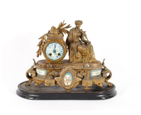 A 19th Century gilded Spelter French mantel clock, having Sevres style porcelain panels, decorated with a figure of a seated 