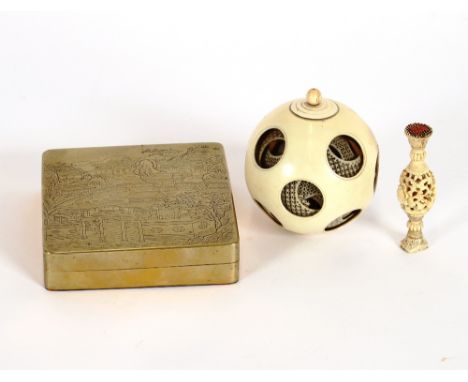 A Chinese engraved brass and copper lined box, decorated with mountains and pagodas; a carved ivory puzzle ball, AF; and a sm