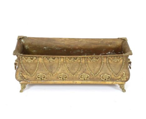 A 19th Century brass planter, having raised foliate decoration, scrolled supports flanked by lion mask ring carrying handles,