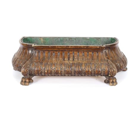 A 19th Century continental walnut planter, having fluted and carved leaf decoration, raised on claw feet, 90cm wide