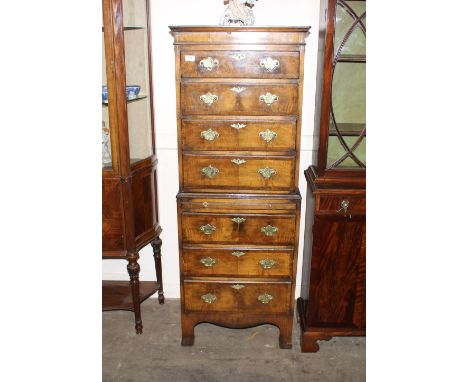 An 18th Century style walnut chest on chest, the upper section fitted four long graduated drawers above a brushing slide with