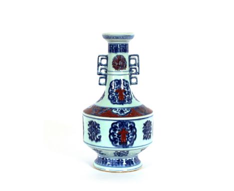 A 19th Century Chinese porcelain copper red and under-glazed blue decorated twin handle vase, having six character mark squar