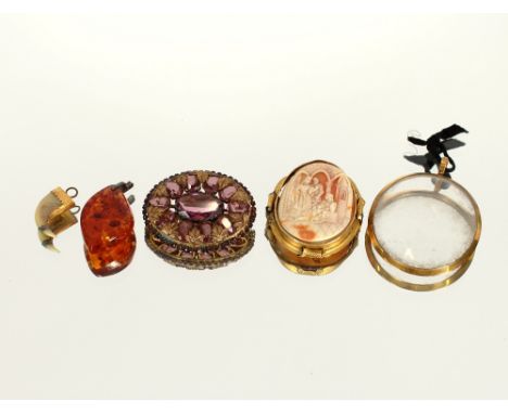 A cameo brooch, with yellow metal mount; an oval brooch set with amethyst coloured stones; a claw pendant with yellow metal m