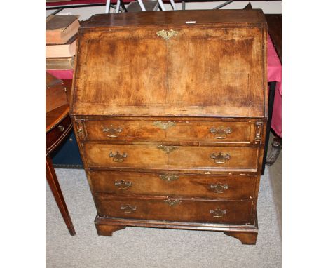 An 18th Century style walnut and cross-banded bureau, the fall front opening to reveal a shaped interior arrangement of drawe