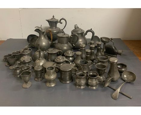 A Large volume of pewter items to include: measures, pepper pots, egg cups, salts, soup ladles, spoon, toddy ladle, ink pots,