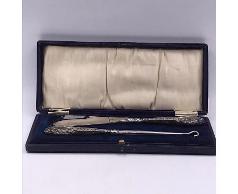 A Cased set of silver handled, hallmarked, button hook and shoehorn.