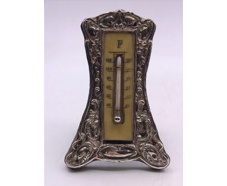 A silver framed thermometer (H10cm)