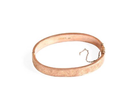 A 9 Carat Gold Hinged Bangle, inner measurements 5.7cm by 5.1cm (a.f.)Gross weight 8.7 grams.
