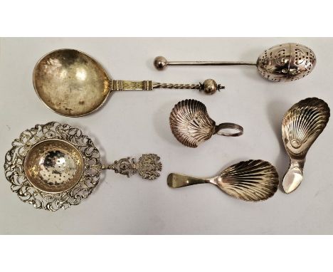 Three Georgian silver tea caddy spoons each with shell bowls, a Victorian egg-shaped tea infuser pierced with foliate designs