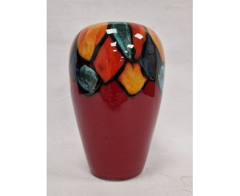Modern Poole pottery vase, circular and tapering, the red ground with abstract petal border, in turquoise, orange, yellow and